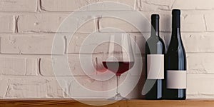 two bottles and glass of red wine on a white brick wall background. Copy space