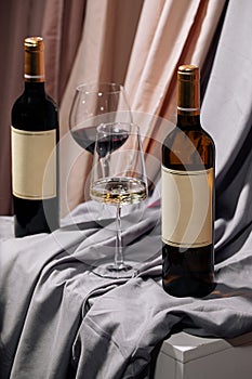 Two bottles and glasses of red and white wine