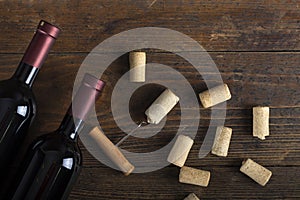 Two bottles of wine, corkscrew and corks. Space for text