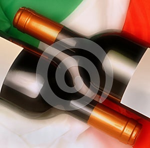 Two bottles of wines with iItalian flag in background