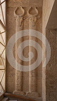 Two bovine headed pilasters at the entrance to the tomb of Rameses III, number 11, in the Valley of the Kings in Luxor, Egypt.