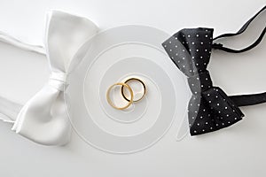 Two bow ties with on the sides of wedding rings