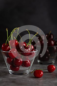 Two bowl of cherries on the table