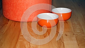 Two-bowl orange decoration and plush tabur on a wooden base