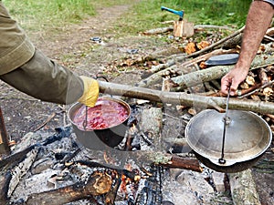 Two bowlers on campfire in hike