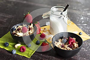 Two bowls of muesli with fresh berries.