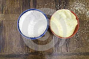 Two bowls of yellow and white Nigerian Garri on Table photo