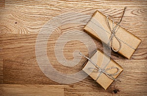 Two boxes in eco paper on the wooden table. Top view.