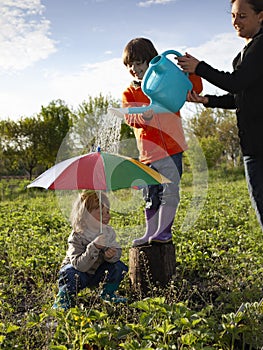 Two Boy Play in rain outdoors, happy brothers game