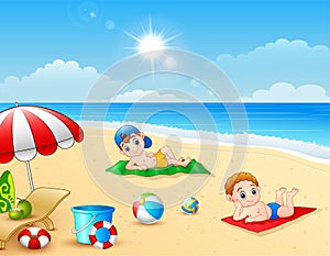 Two boy sunbathing on the beach mat
