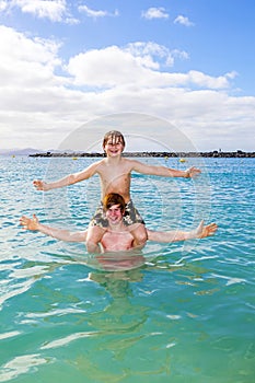 Two boys and brother have fun in the ocean