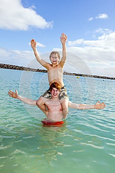 Two boys and brother have fun in the ocean