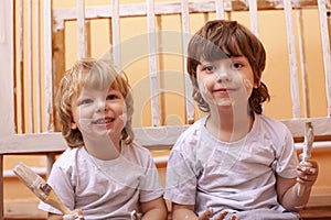 Two boys with brush repairing home