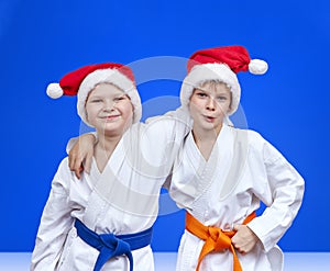 Two boys in caps of Santa Claus