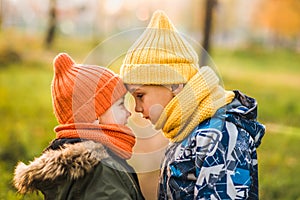 Two boys in colored hats stand opposite each other