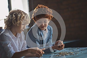 Two boys counting coins and looking busy