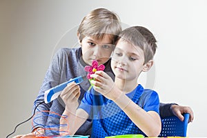 Two boys creating with 3d printing pen