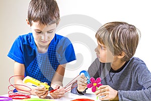 Two boys creating with 3d printing pen