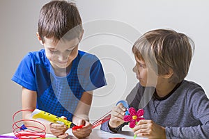 Two boys creating with 3d printing pen