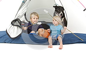 Two boys and dog tenting