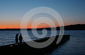 Two boys with father on an evening fishing