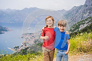 Two boys friend enjoys the view of Kotor. Montenegro. Bay of Kotor, Gulf of Kotor, Boka Kotorska and walled old city