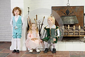 Two boys and girl in medieval costumes are near