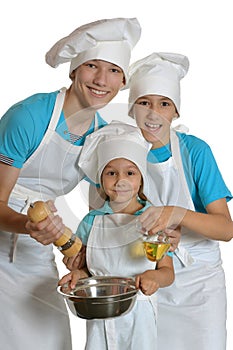 Two boys and girl in white aprons