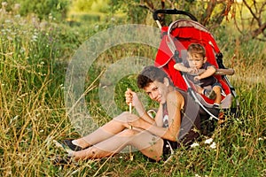 Two boys have a rest in the summer in the park in the nature