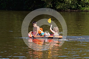 Two Boys Having Fun on Inflatable Rubber Boat