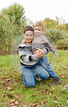 Two boys having fun together outdoor. Happy family. Brothers embracing