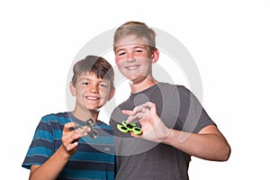 Two boys holding fidget spinners