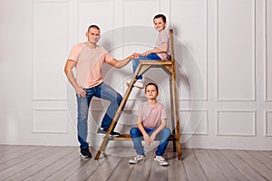 Two boys in jeans and a man. happy father and two sons