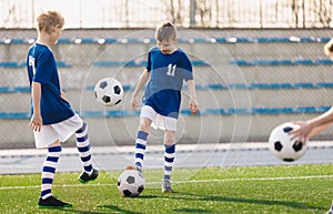 Two Boys Juggling Balls on Training Drill. Child Kicking Ball