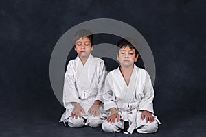 Two boys of the karate in a white kimono