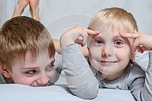 Two boys lie and smiling. Brothers best friends. Fair-haired blonde boys. Portrait