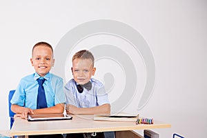 The two boys are looking at Internet Tablet school