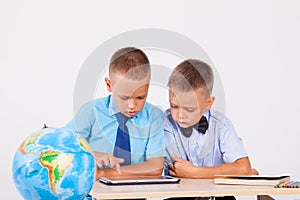 The two boys are looking at Internet Tablet school