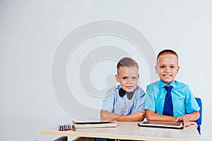 The two boys are looking at Internet Tablet school