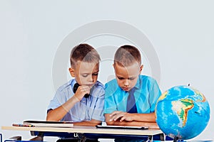 The two boys are looking at Internet Tablet school