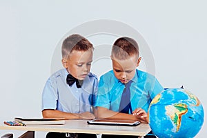 The two boys are looking at Internet Tablet school