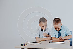 The two boys are looking at Internet Tablet school