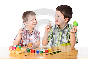 Two boys painting easter eggs