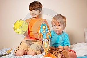 Two boys play astronauts and rocker liftoff