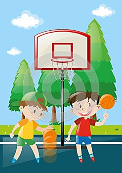 Two boys playing basketball in court