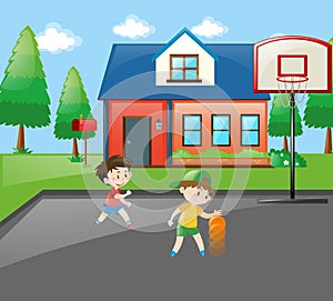 Two boys playing basketball at home