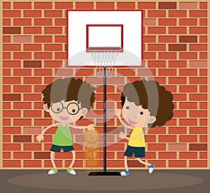 Two boys playing basketball on the road