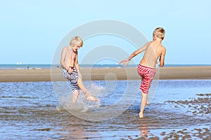 Two boys playing on the beach