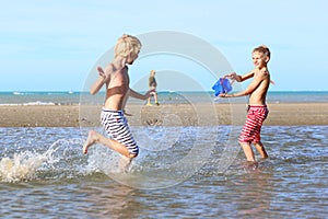 Two boys playing on the beach