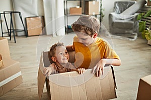 Two Boys Playing with Boxes in New Home